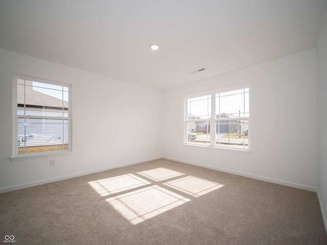 carpeted empty room with recessed lighting and baseboards