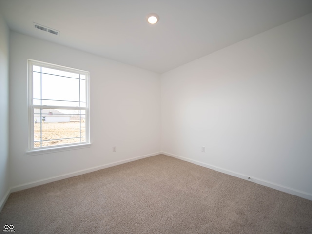 carpeted spare room with recessed lighting, visible vents, and baseboards