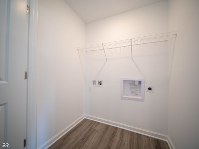 laundry area with laundry area, dark wood-type flooring, washer hookup, baseboards, and electric dryer hookup