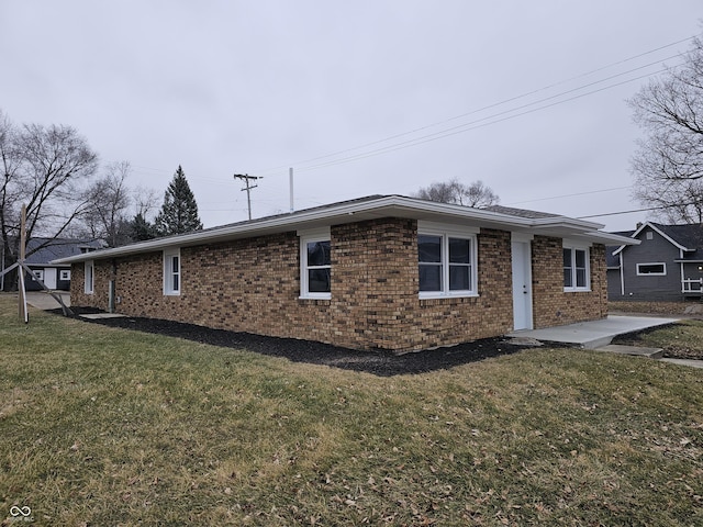 view of home's exterior with a yard and a patio area