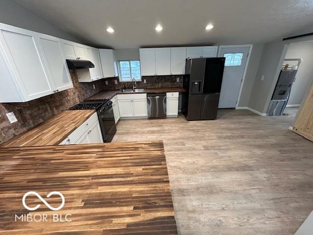 kitchen featuring sink, tasteful backsplash, black appliances, white cabinets, and light wood-type flooring