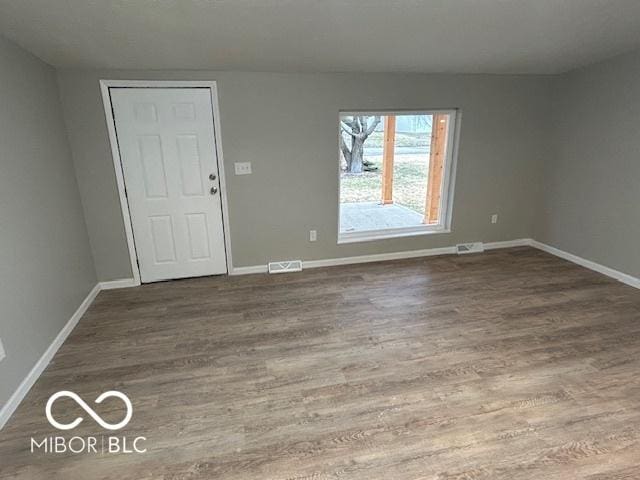 unfurnished room featuring hardwood / wood-style floors