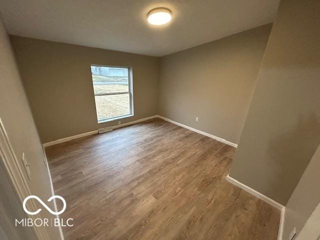 spare room featuring hardwood / wood-style flooring