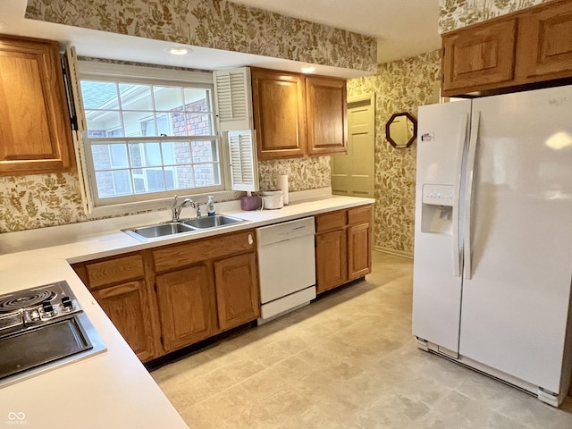 kitchen featuring sink and white appliances