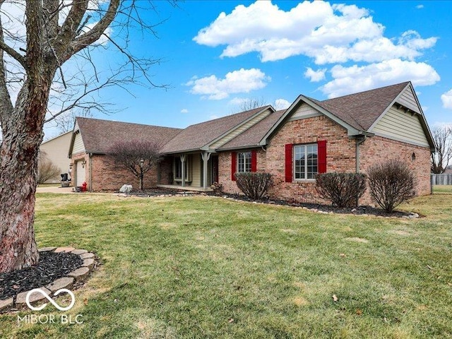 ranch-style home featuring a garage and a front lawn