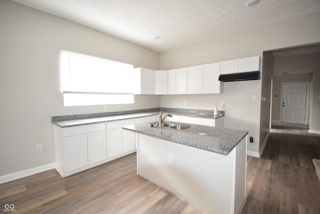 10 N Keystone Ave, Indianapolis, IN 46201 - kitchen with sink, stone countertops, a center island with sink, hardwood / wood-style floors, and white cabinets