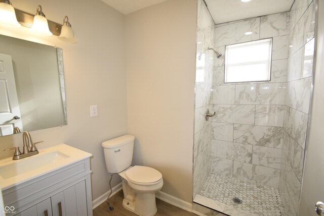 10 N Keystone Ave, Indianapolis, IN 46201 - bathroom featuring vanity, toilet, and a tile shower