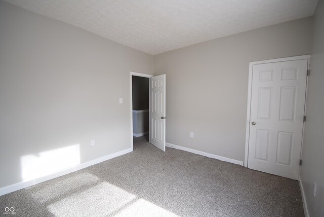 10 N Keystone Ave, Indianapolis, IN 46201 - unfurnished bedroom with carpet flooring and a textured ceiling