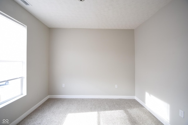 10 N Keystone Ave, Indianapolis, IN 46201 - empty room with a textured ceiling and carpet flooring