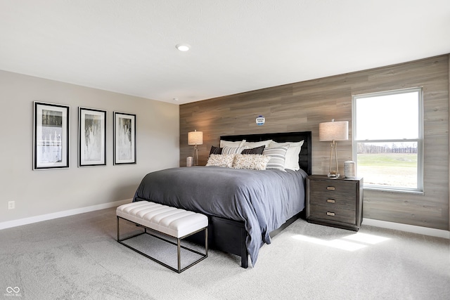 carpeted bedroom with wood walls