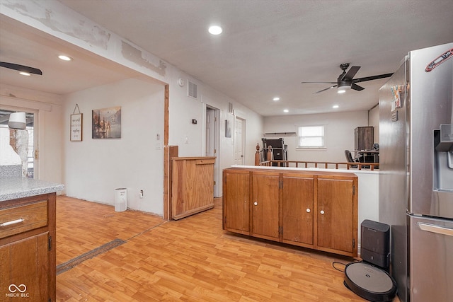 kitchen with stainless steel fridge with ice dispenser, light hardwood / wood-style flooring, kitchen peninsula, and ceiling fan