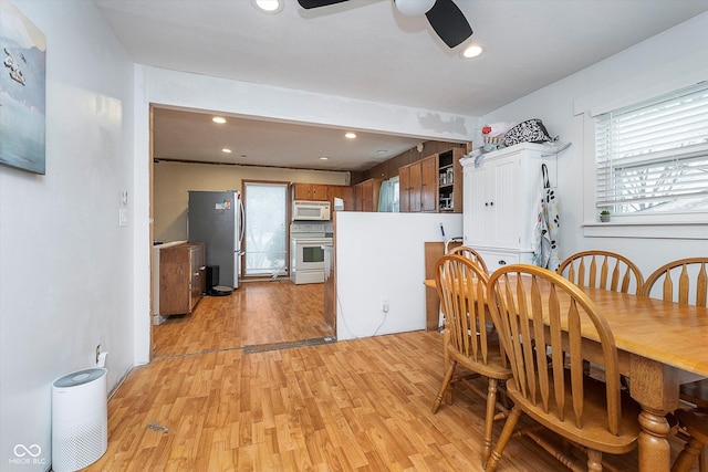 dining space with ceiling fan and light hardwood / wood-style floors