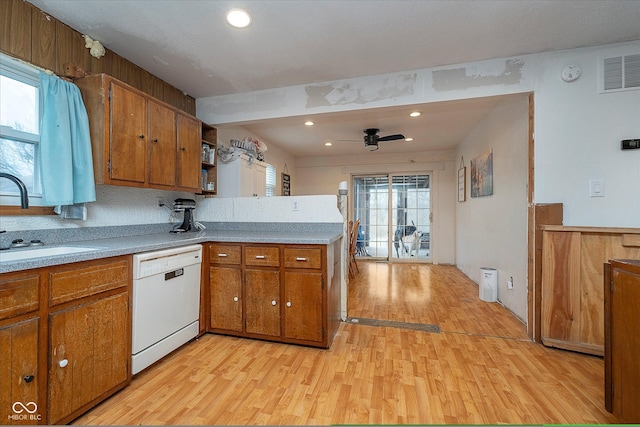 kitchen featuring ceiling fan, dishwasher, sink, and light wood-type flooring