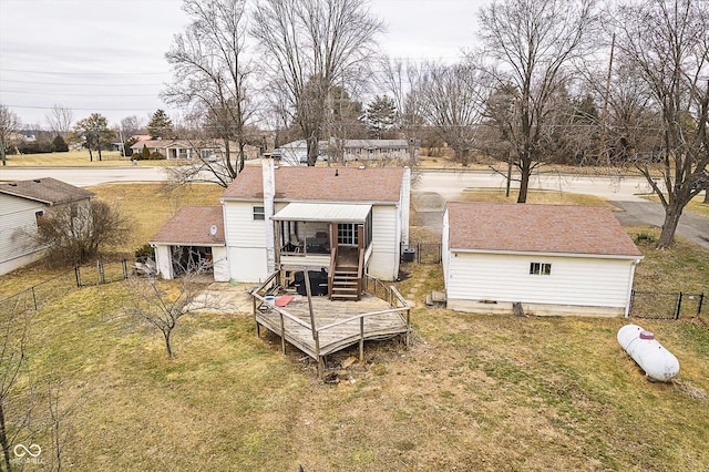 rear view of house featuring a lawn