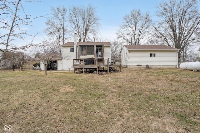 back of property with a sunroom, a yard, and a deck