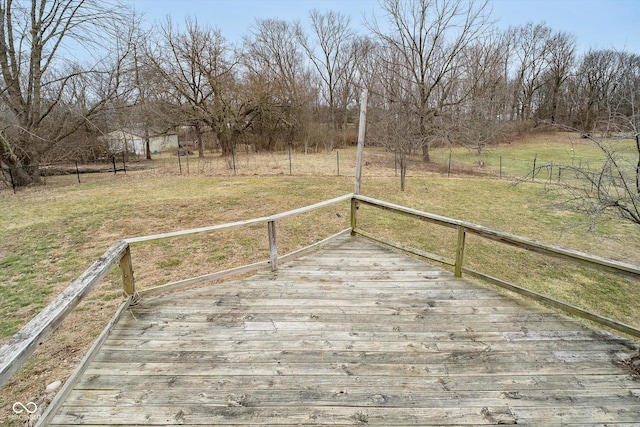 wooden terrace featuring a lawn