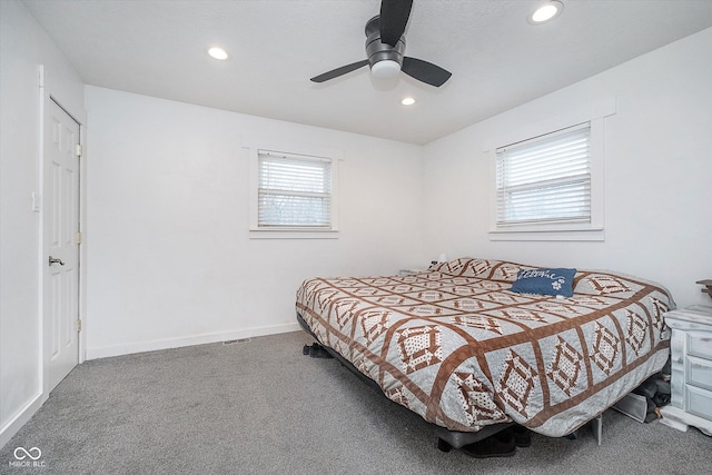 bedroom with multiple windows, ceiling fan, and carpet flooring