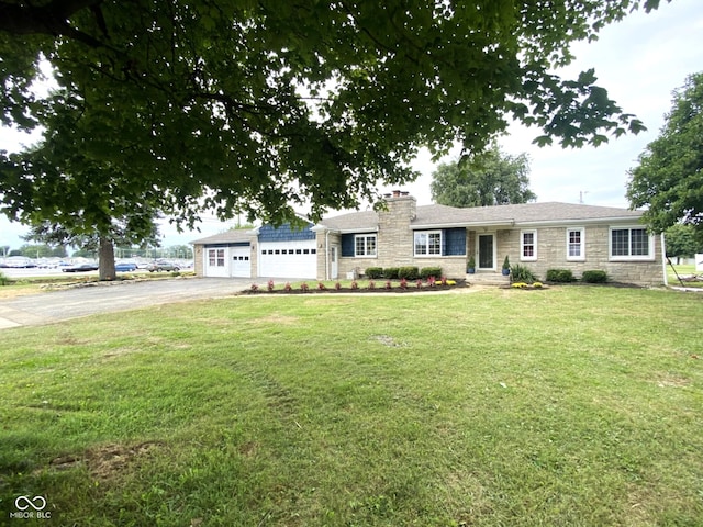 ranch-style home with a garage and a front lawn