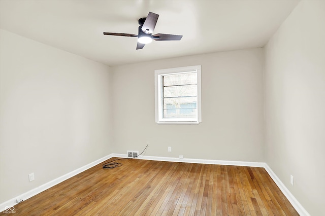 spare room with wood-type flooring and ceiling fan