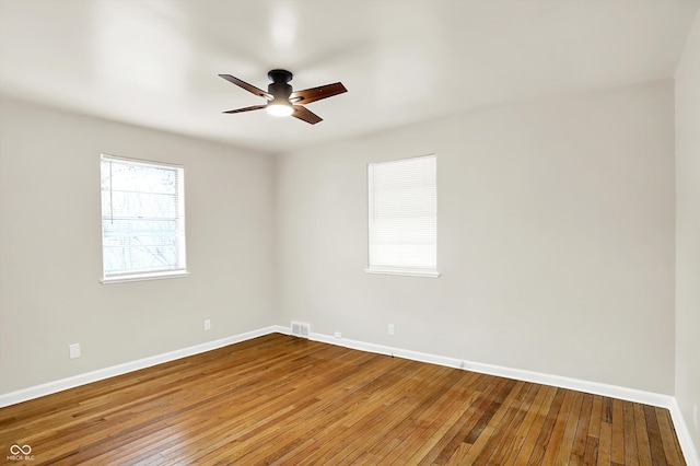 empty room with hardwood / wood-style flooring and ceiling fan