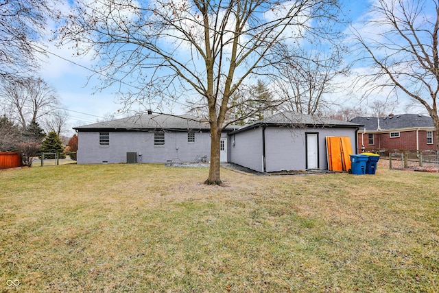 back of house with cooling unit and a lawn