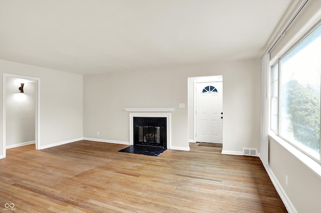 unfurnished living room featuring light hardwood / wood-style flooring