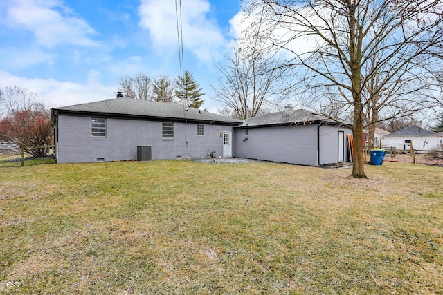 rear view of house with a yard and central air condition unit