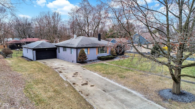 single story home featuring a garage and a front lawn