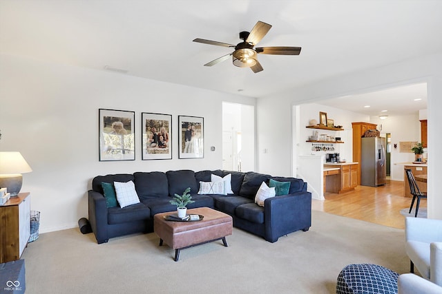 carpeted living room featuring ceiling fan