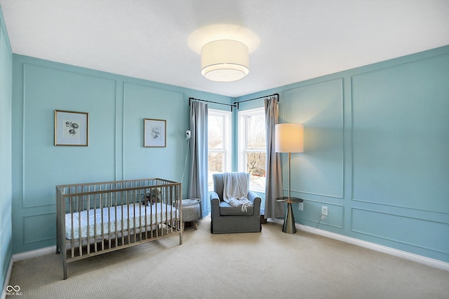 bedroom featuring a crib and carpet floors