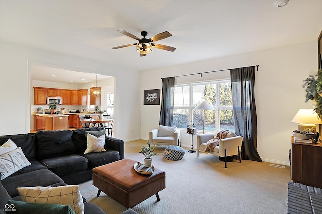 living room with ceiling fan and light carpet