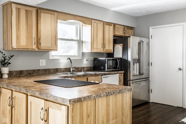 kitchen featuring light brown cabinetry, sink, stainless steel fridge, dishwashing machine, and dark wood-type flooring