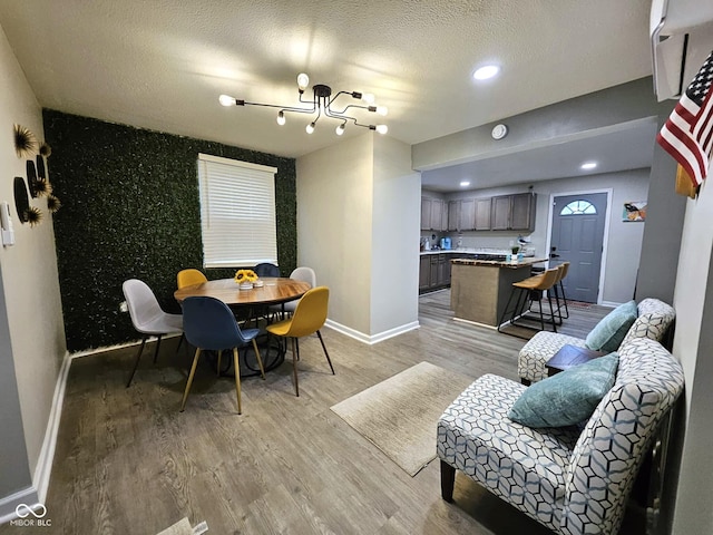 living room with light hardwood / wood-style floors and a textured ceiling