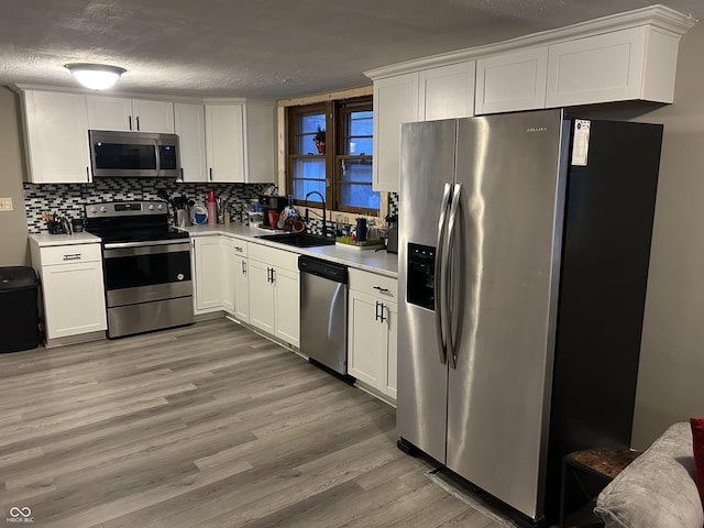 kitchen with white cabinetry, sink, and appliances with stainless steel finishes