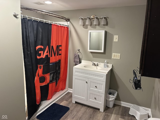 bathroom featuring vanity, hardwood / wood-style flooring, and a shower with shower curtain