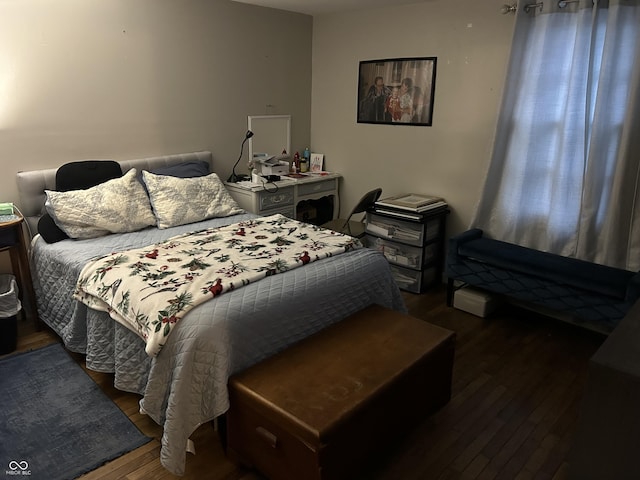 bedroom with dark hardwood / wood-style floors