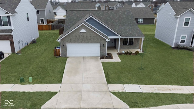 view of front of home featuring a garage, a front yard, and central air condition unit