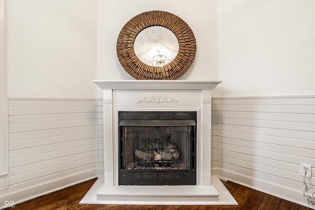 room details featuring hardwood / wood-style floors and wood walls