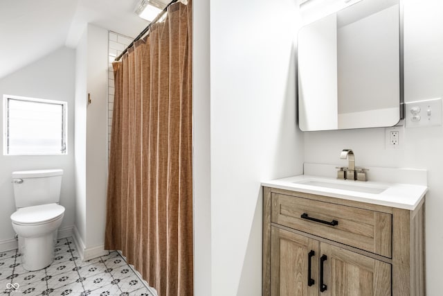 bathroom with vanity, vaulted ceiling, toilet, and walk in shower