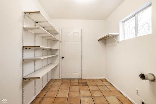 walk in closet featuring light tile patterned flooring