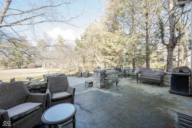 view of patio / terrace featuring outdoor dining area, a grill, and an outdoor living space