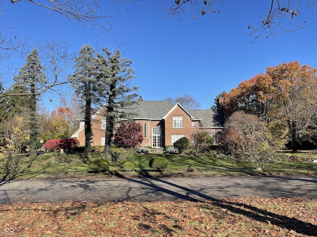 view of front of home with a front lawn and a chimney