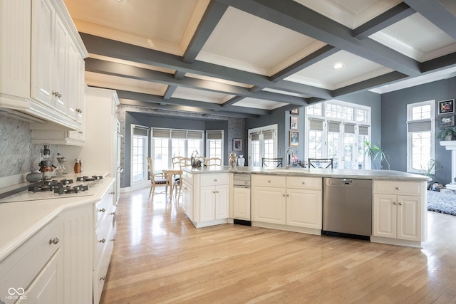 kitchen featuring white gas stovetop, coffered ceiling, light countertops, light wood-type flooring, and stainless steel dishwasher