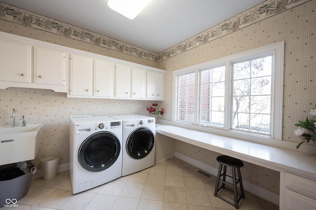 laundry room featuring light tile patterned floors, cabinet space, visible vents, washing machine and dryer, and wallpapered walls