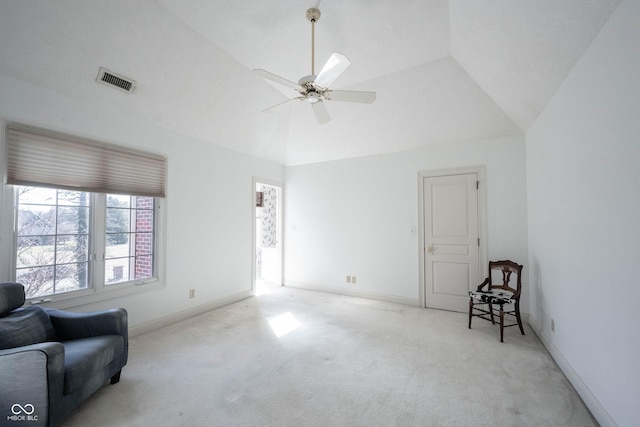 living area featuring lofted ceiling, carpet, visible vents, and baseboards