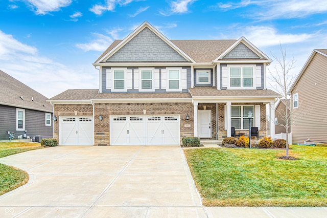 craftsman-style home with concrete driveway, roof with shingles, a front yard, a porch, and brick siding