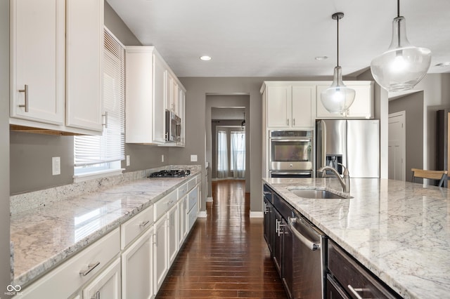 kitchen with white cabinetry, dark wood-style flooring, appliances with stainless steel finishes, and a sink