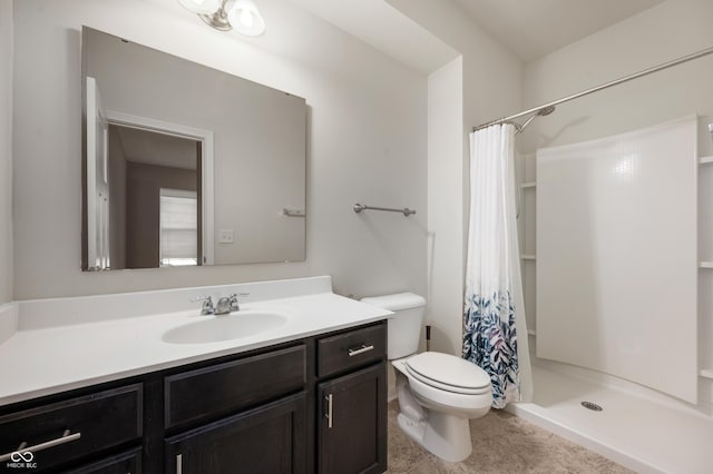 full bath featuring vanity, a shower stall, and toilet