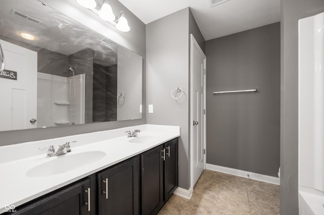 full bath featuring double vanity, visible vents, walk in shower, and a sink