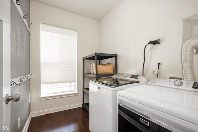 laundry area featuring washer and dryer, baseboards, dark wood-style flooring, and laundry area